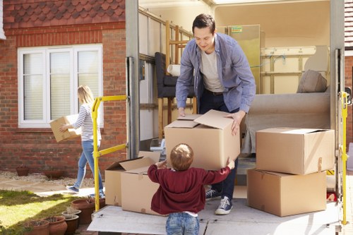 Professional team handling piano removals in Tottenham with protective equipment
