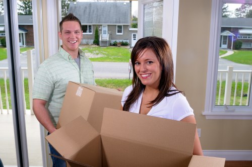 Man and van service team loading household items into a van