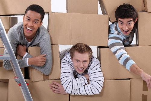 Packed moving boxes and furniture ready for a removal truck in Tottenham