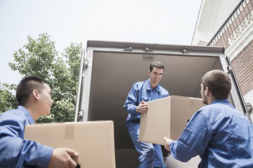 Professional furniture removals team handling a sofa in Tottenham