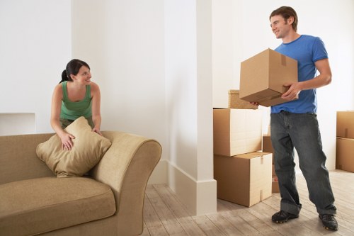 Specialist movers navigating stairs during piano removals in Tottenham